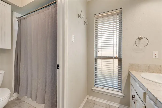 a bathroom with a shower curtain and a sink