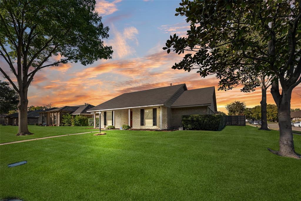 1923 Baylor Drive Richardson, TX 75081 - Photo 36 of 39 a view of a house next to a big yard and large trees