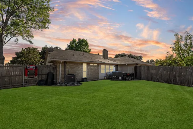 a view of a house with a yard and porch