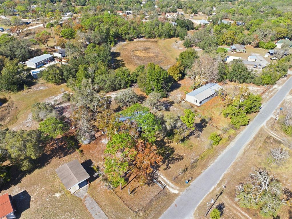 8045 Indian Trail Road Weeki Wachee, FL 34613 - Photo 48 of 49 an aerial view of a house with a yard and lake view in back