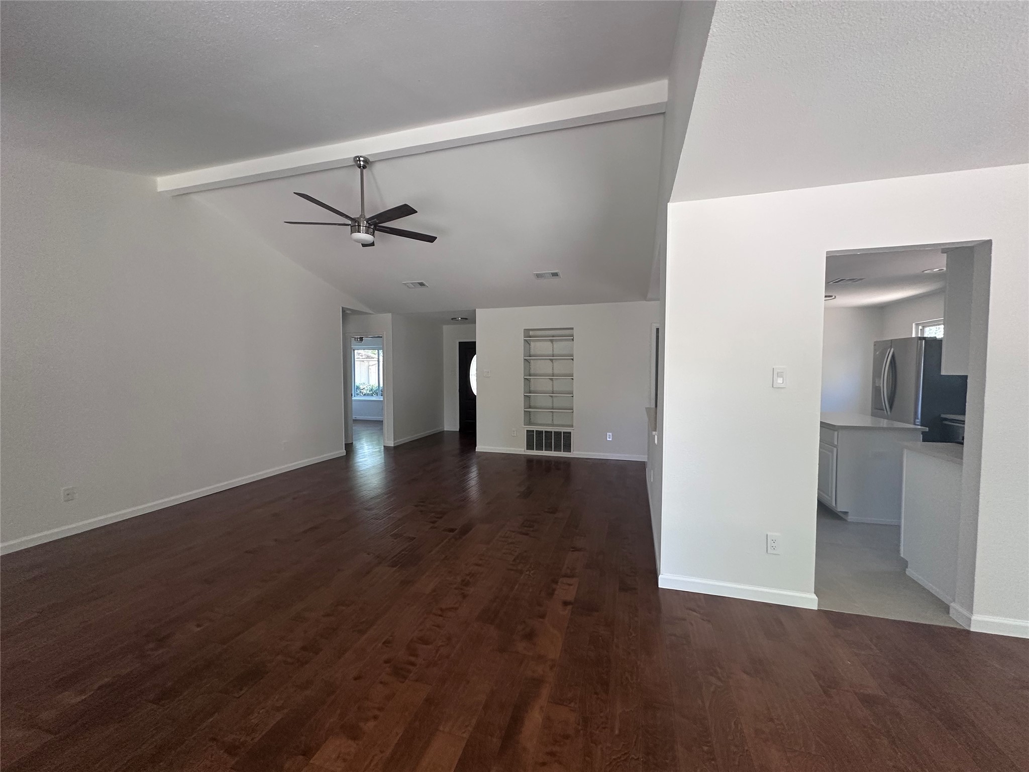 12610 Andromeda Cove Austin, TX 78727 - Photo 6 of 29 Rich hardwood flooring complements the vaulted ceiling and open architectural flow of this main level.