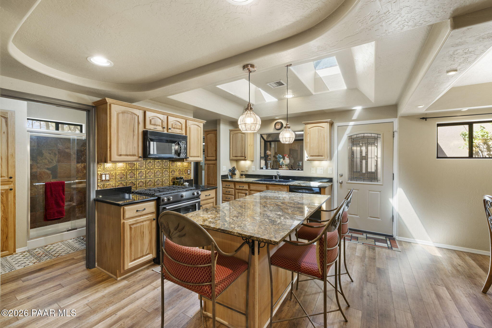 535 Copper Basin Road Prescott, AZ 86303 - Photo 12 of 41 a kitchen with stainless steel appliances granite countertop a stove top oven a refrigerator a sink and dishwasher