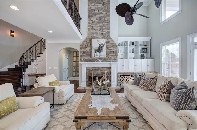 a living room with furniture a flat screen tv and a fireplace