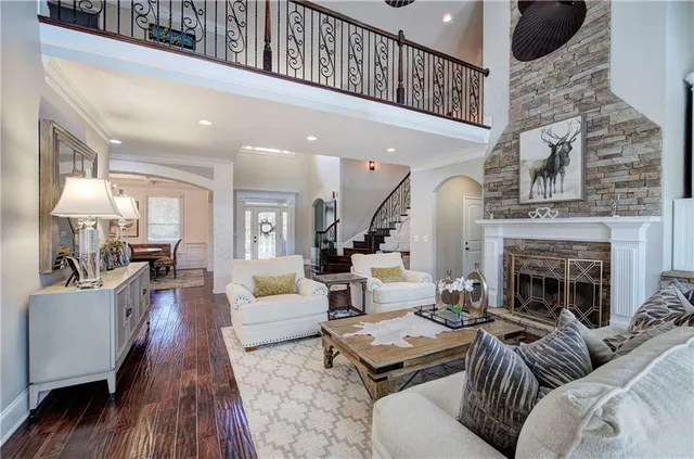 a spacious bedroom with a bed a couch and a chandelier