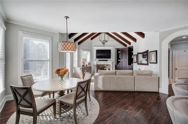 a bedroom with a bed couches chair and a large window