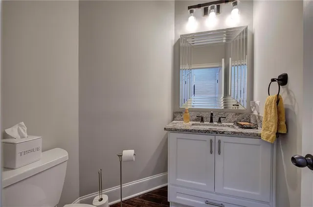 a gym room with lots of furniture and a chandelier