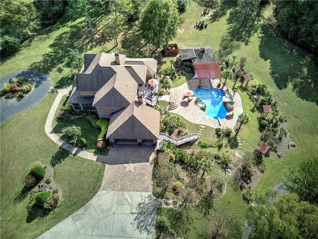 an aerial view of a house with yard swimming pool and outdoor seating