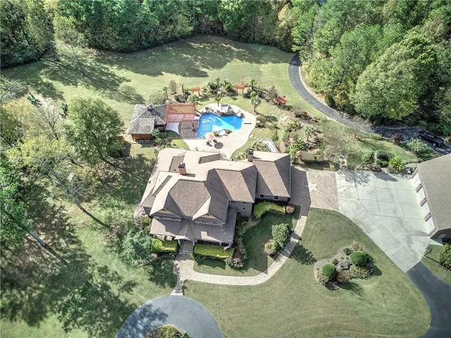 an aerial view of a house with a yard
