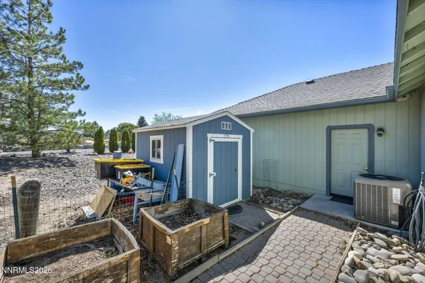 a view of a dry yard with wooden fence