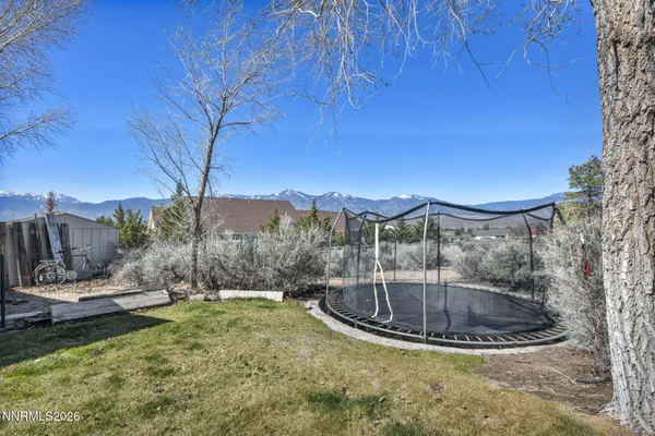 an aerial view of residential houses with yard