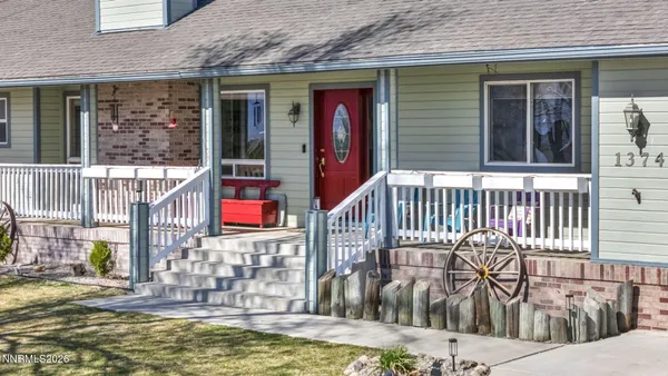 a view of a house with a small yard and wooden floor and fence