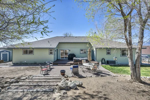 a front view of a house with outdoor seating