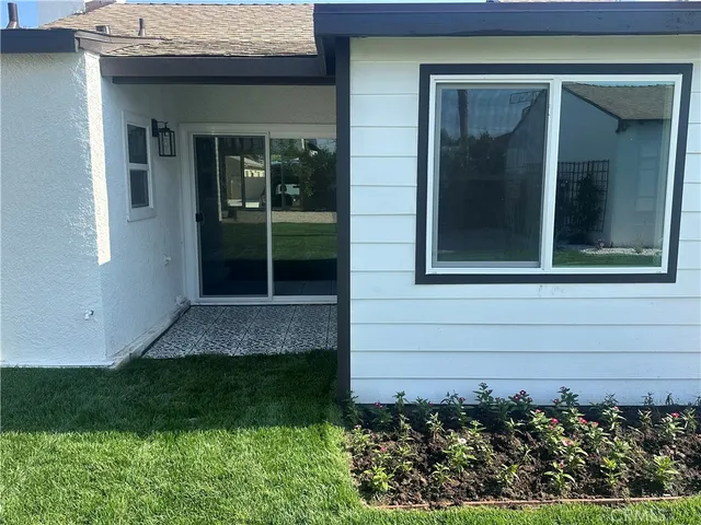 a view of front door of house and yard