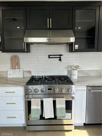 a stove top oven sitting inside of a kitchen