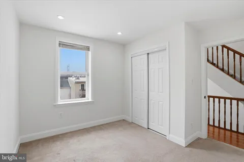 an empty room with windows & cabinet