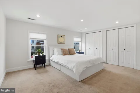 a spacious bedroom with a bed and a couch