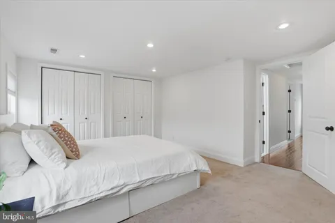 a bedroom with a bed and a painting