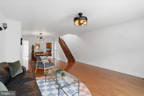 a view of a workspace with furniture and wooden floor