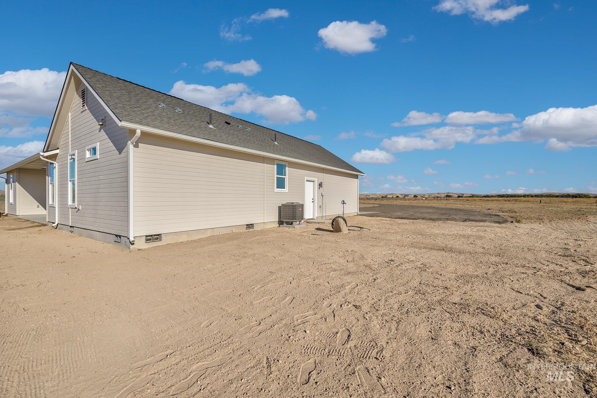 1371 Hansen Road Weiser, ID 83672 - Photo 35 of 44 Light-toned siding exterior with a dark-pitched roof and white trim