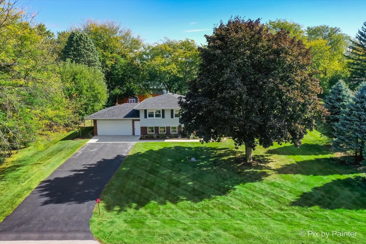 12N243 Hilltop Road Elgin, IL 60123 - Photo 4 of 41 a view of a house with a yard