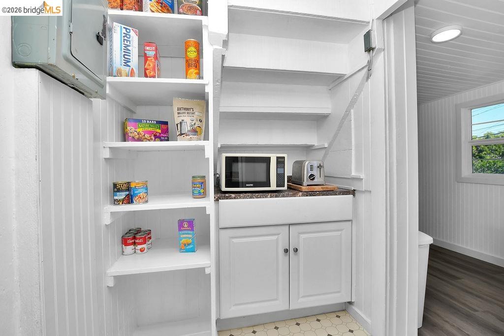 325 South 2nd Street Rio Vista, CA 94571 - Photo 16 of 33 Built-in storage pantry featuring white shelving, beadboard paneling, and a compact counter area with cabinetry