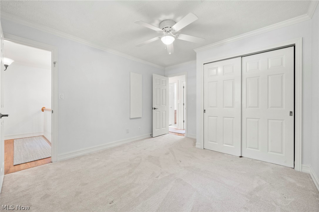 3871 Greentree Road Stow, OH 44224 - Photo 27 of 50 Bedroom featuring light-toned carpeting, crown molding, and a ceiling fan with integrated lighting