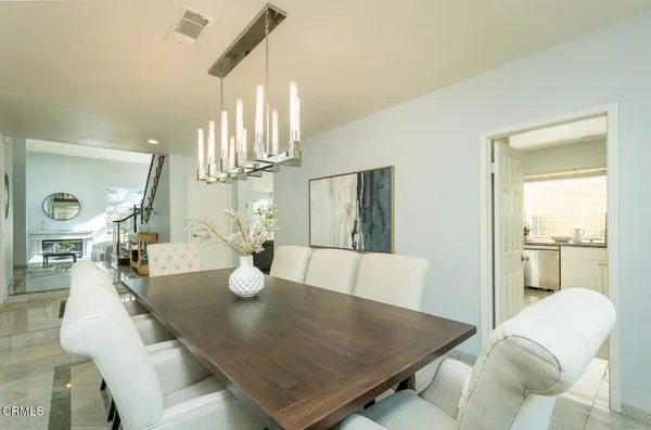 a view of a dining room with furniture and a window