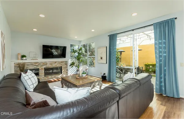 a living room with furniture and a potted plant