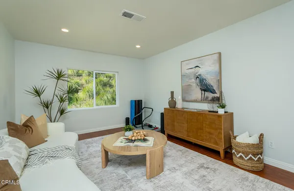 a living room with furniture and a potted plant