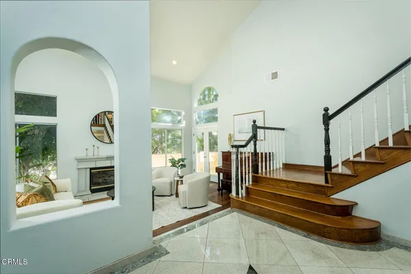 a view of entryway kitchen and hall with wooden floor