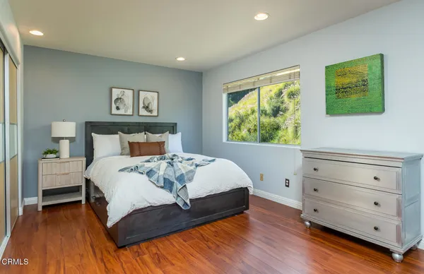 a bedroom with a bed dresser and a window