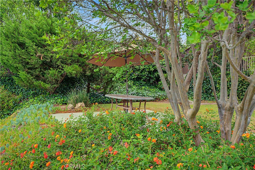 22671 Town Crier Road Calabasas, CA 91302 - Photo 9 of 35 a view of a garden with a bench