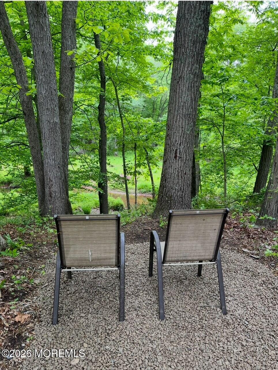 724 Monmouth Road, Unit 34 Cream Ridge, NJ 08514 - Photo 11 of 18 a view of a wooden bench in a backyard
