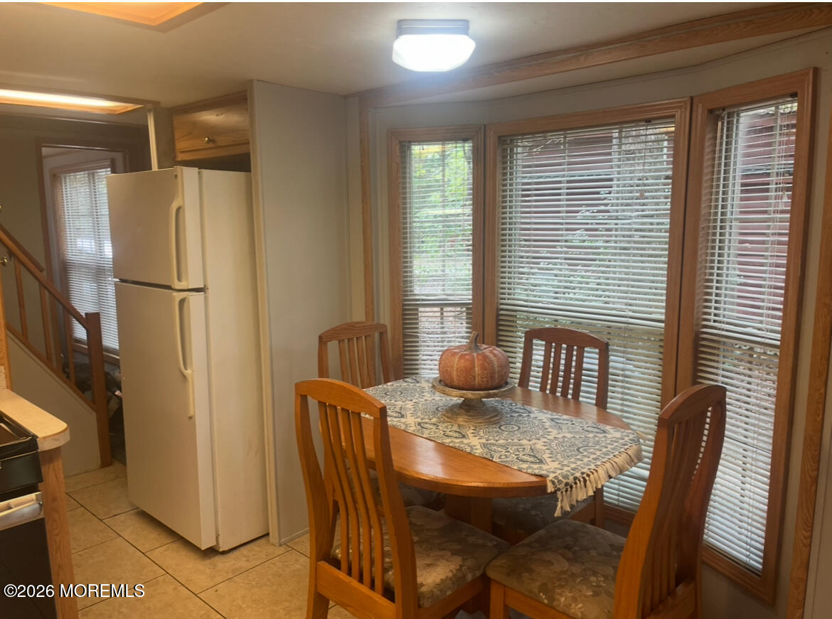 724 Monmouth Road, Unit 34 Cream Ridge, NJ 08514 - Photo 4 of 18 a view of a dining room with furniture window and wooden floor