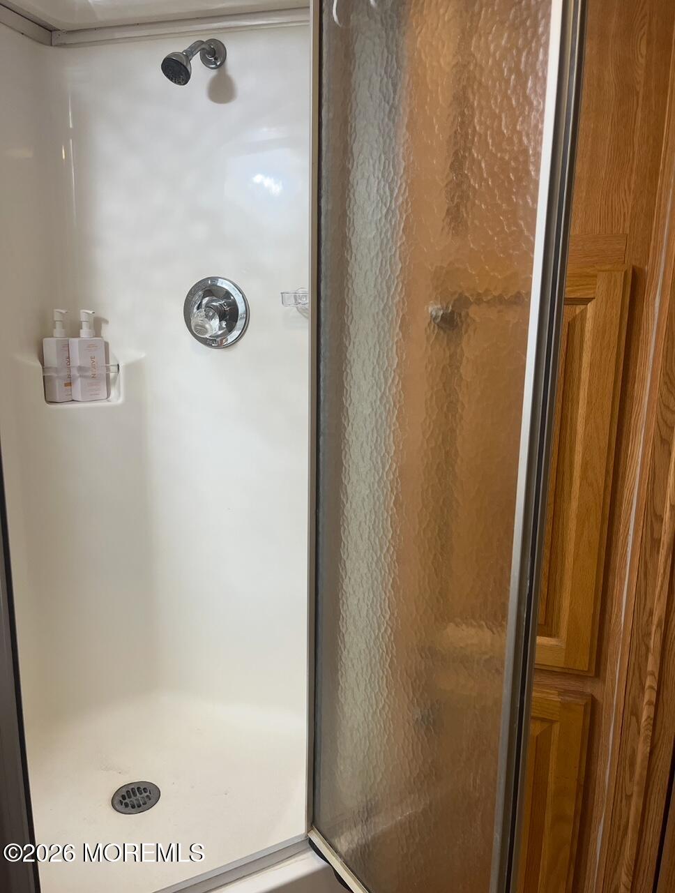 724 Monmouth Road, Unit 34 Cream Ridge, NJ 08514 - Photo 8 of 18 a bathroom with a glass shower door