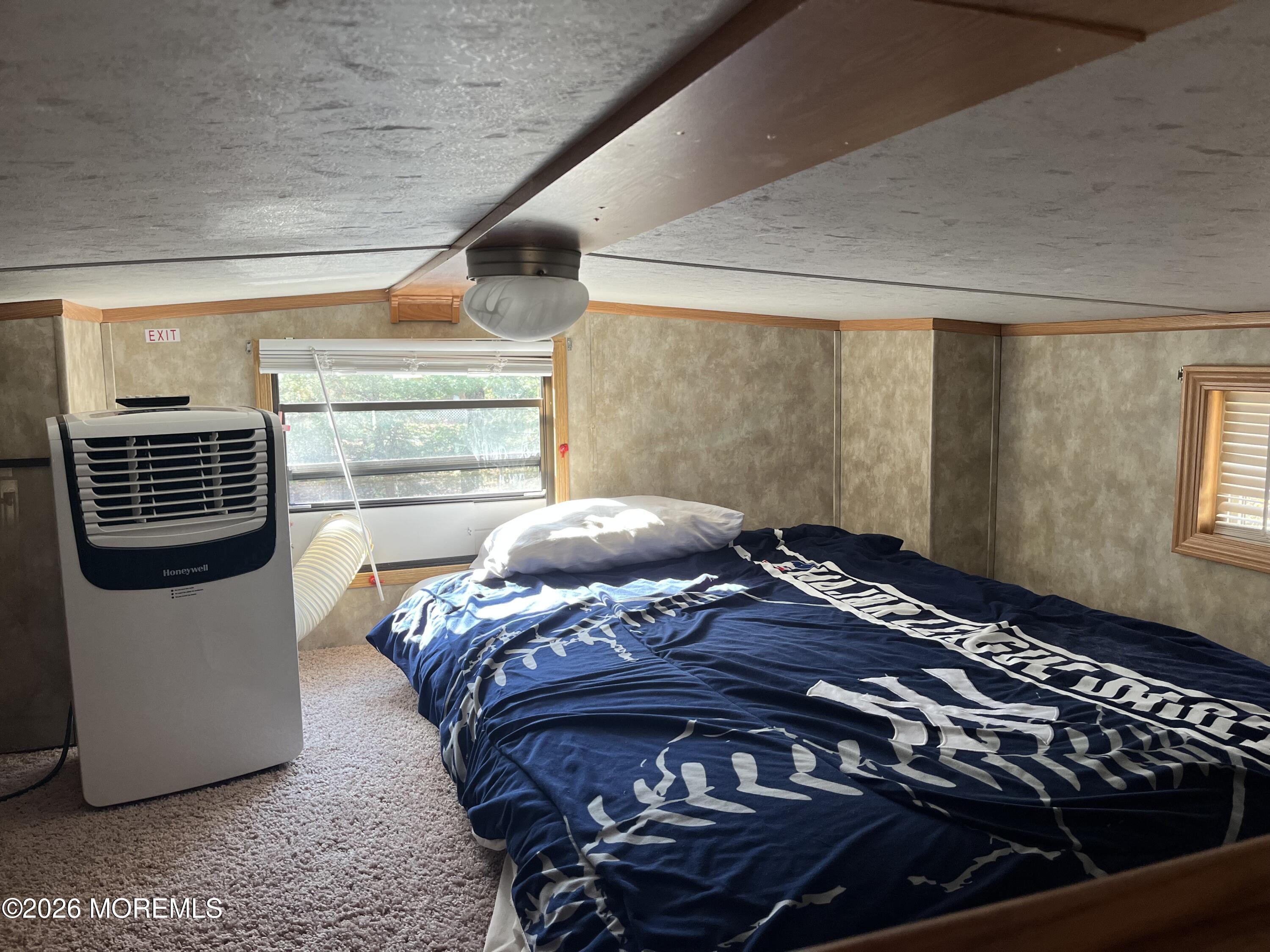 724 Monmouth Road, Unit 34 Cream Ridge, NJ 08514 - Photo 10 of 18 a bed sitting in a bedroom next to a window