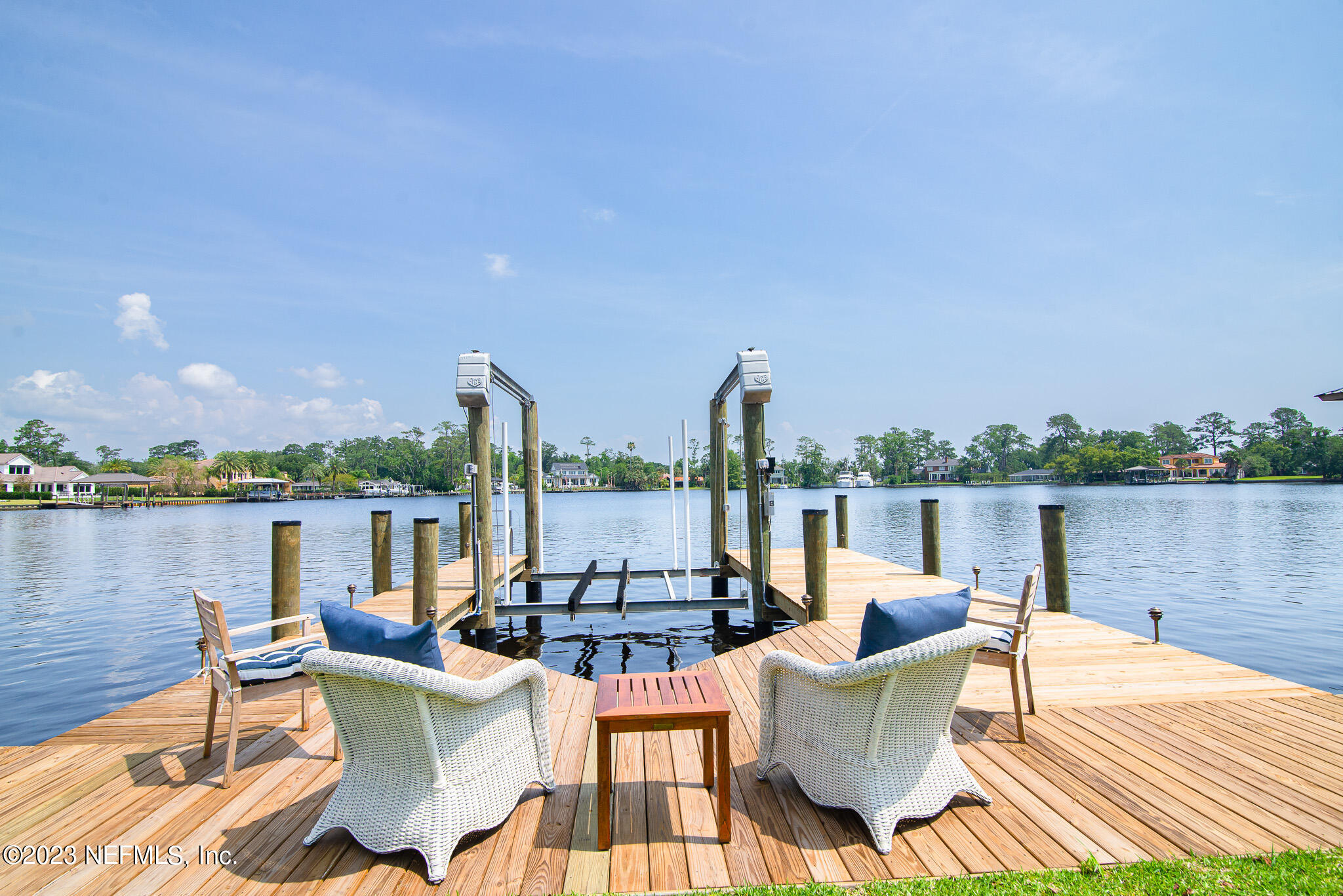 a view of a lake with couches chairs