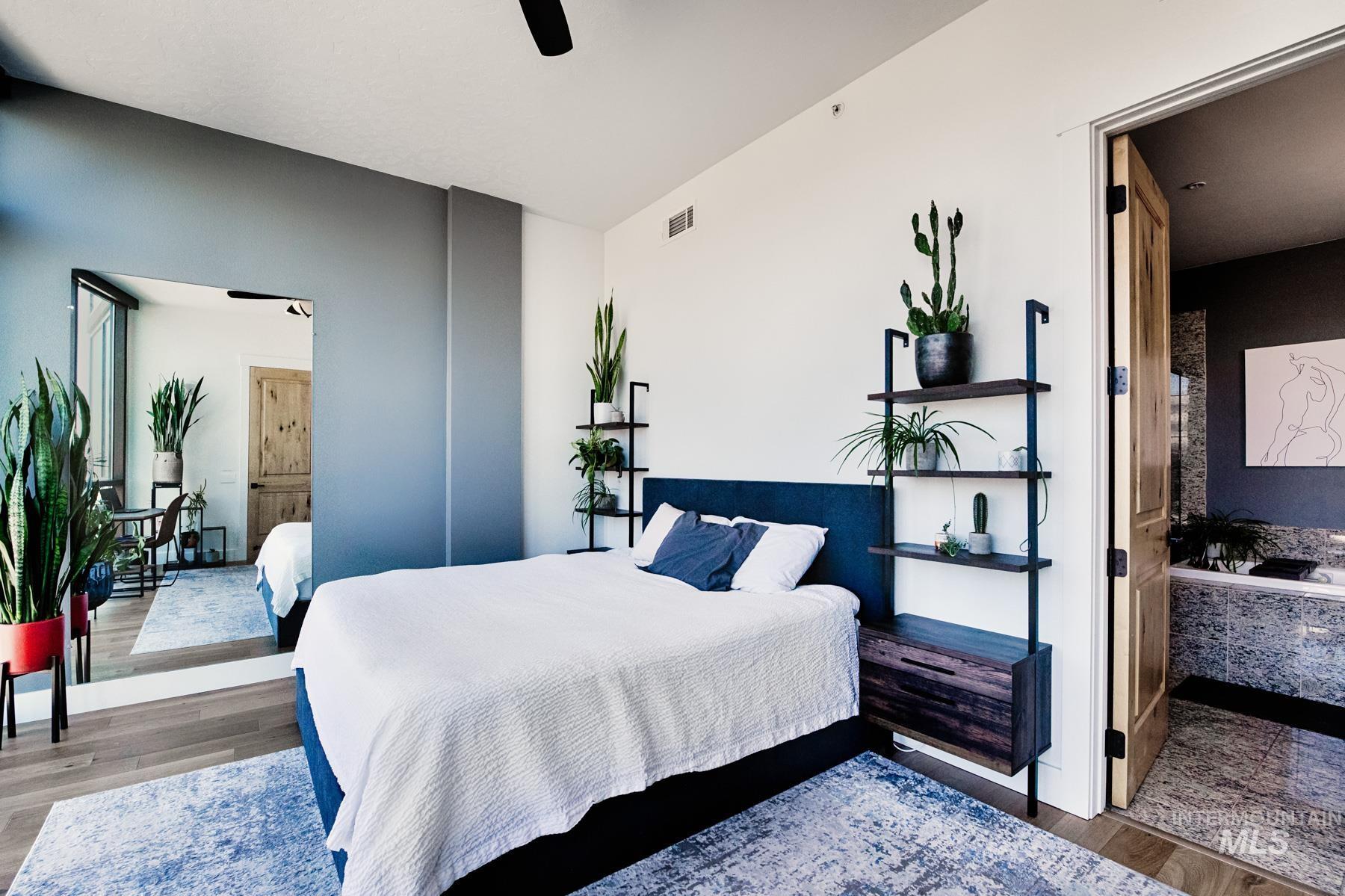 851 West Front Street, Unit 1004 Boise, ID 83702 - Photo 12 of 27 Bedroom featuring wood finished floors and ceiling fan