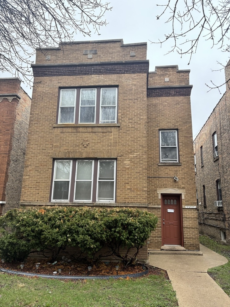 1711 North Austin Avenue Chicago, IL 60639 - Photo 1 of 13 a front view of a house with garden