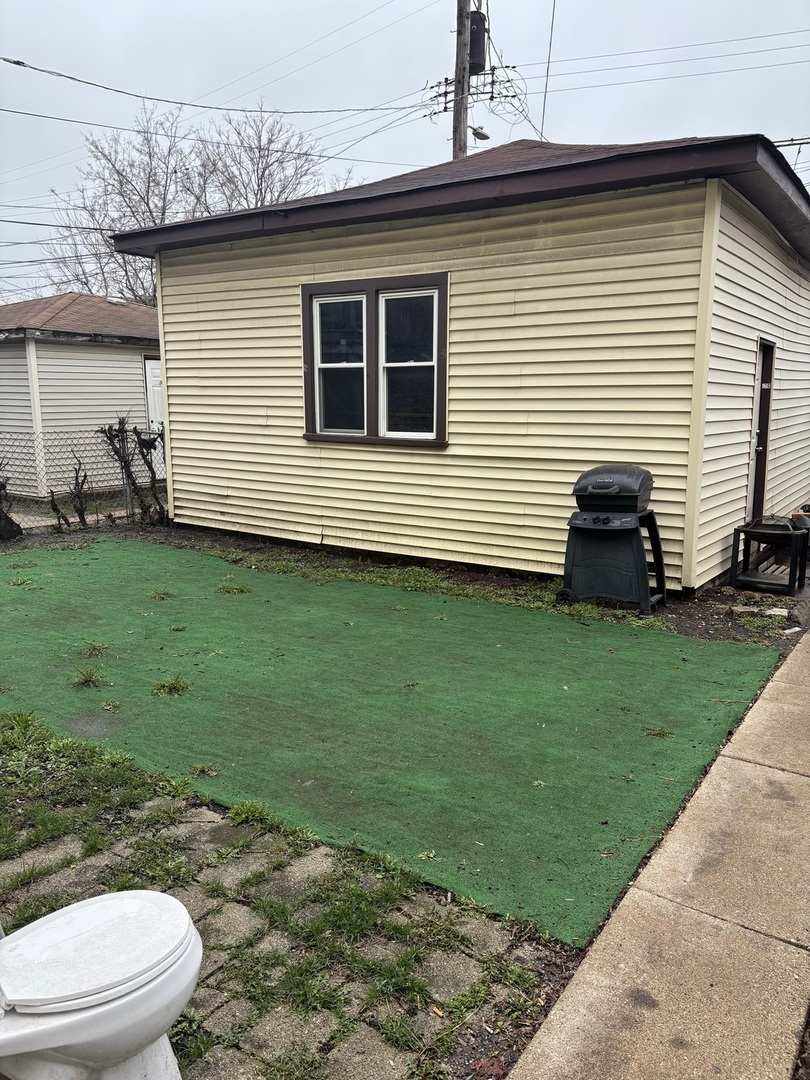 1711 North Austin Avenue Chicago, IL 60639 - Photo 12 of 13 a front view of a house with garden