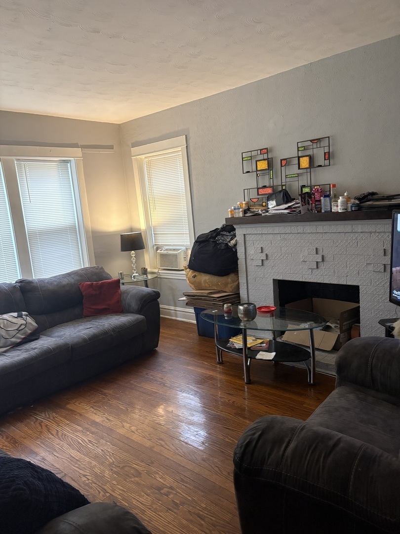 1711 North Austin Avenue Chicago, IL 60639 - Photo 5 of 13 a living room with furniture and a fireplace