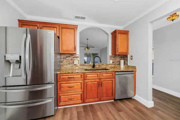 a kitchen with stainless steel appliances a refrigerator and a sink
