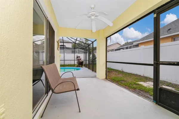 a view of a porch with furniture and a yard