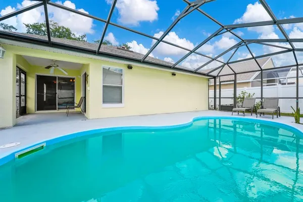 a swimming pool with yard in front of it