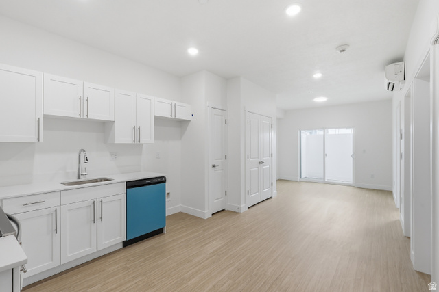 2085 North Main Street, Unit 301 Sunset, UT 84015 - Photo 2 of 20 Entrance opens onto kitchen featuring white cabinetry, dishwashing machine, light wood-style floors, recessed lighting, and light stone countertops