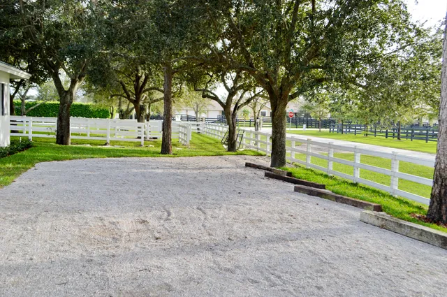 a view of a hallway with a white walls and stairs
