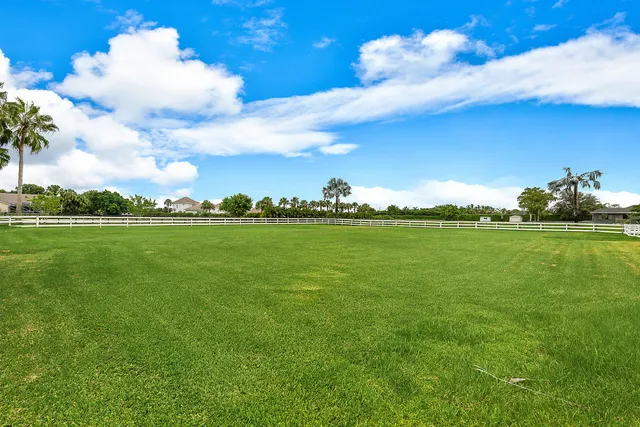 an aerial view of residential houses with outdoor space and street view