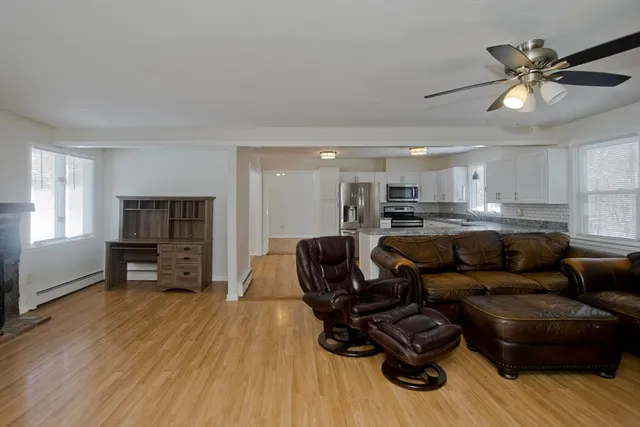 a living room with furniture and a wooden floor