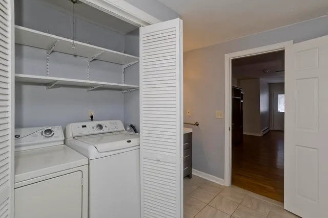 a view of storage and utility room with washer and dryer