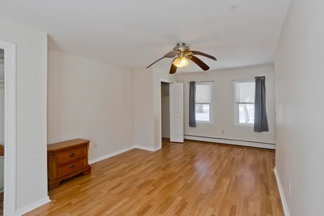 a view of room with wooden floor and windows